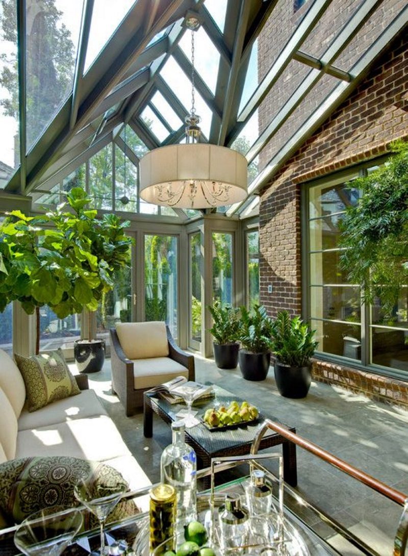 glass and steel attached sunroom design with picture windows casing matching sunroom door frame and brick siding with glass and stainless steel wheeled food tray