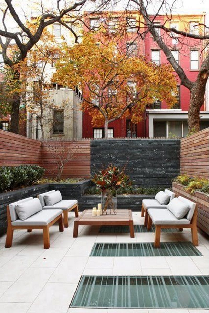 multi-level raised beds with plexiglass floor panel accents and painted accent wall with custom wood chairs and table and tall rectangular glass vase